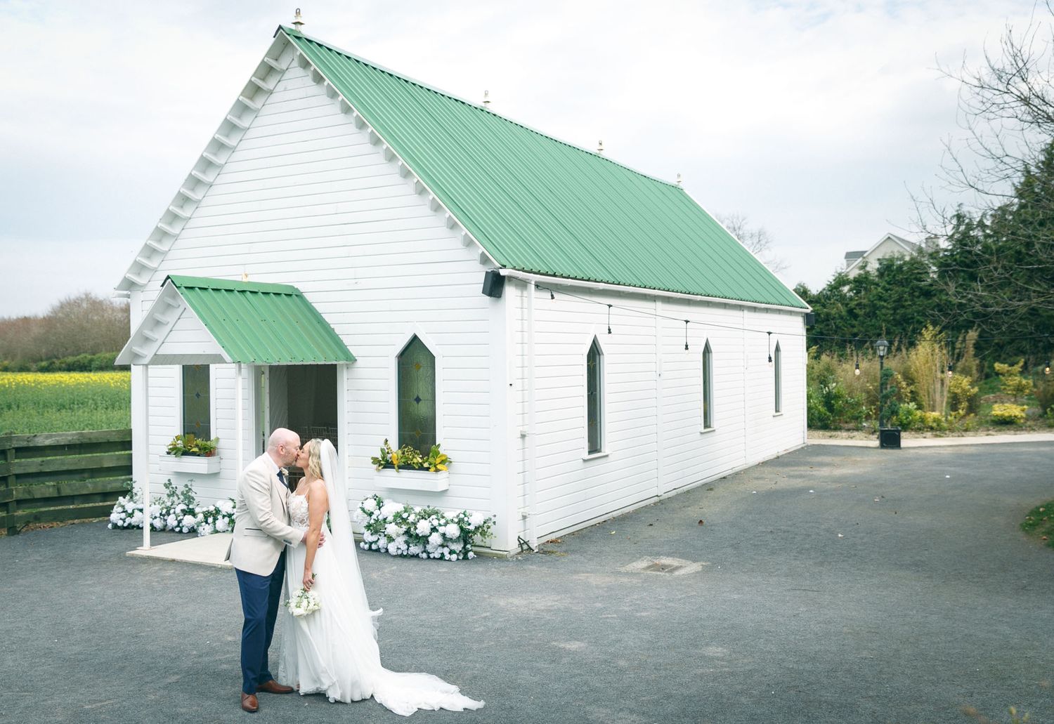 Bride and groom kissing outdoors in natural light.