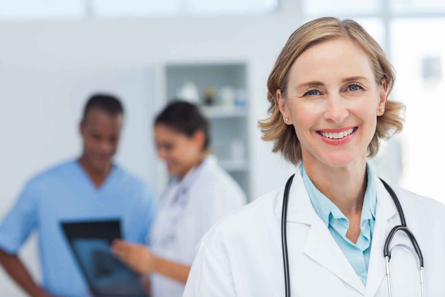 Corporate portrait of a smiling medical professional.