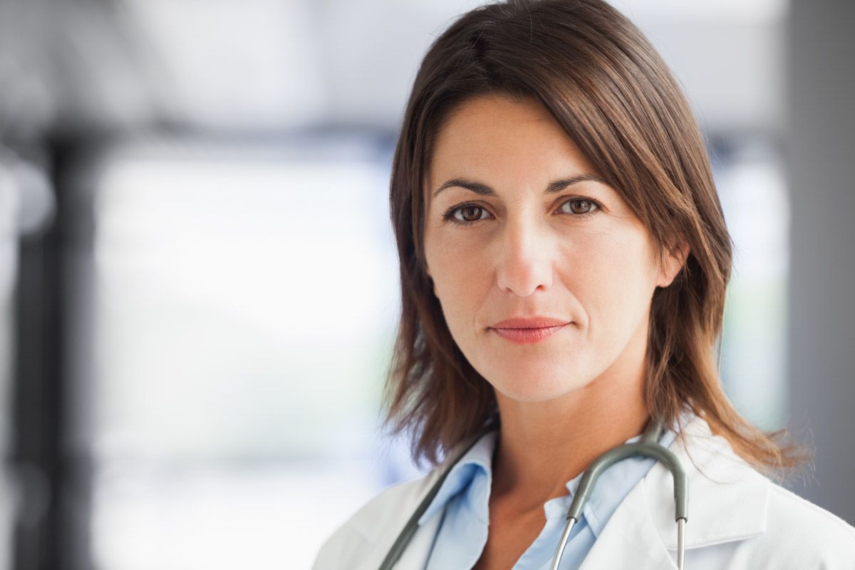 Confident  medical professional standing in a workplace.