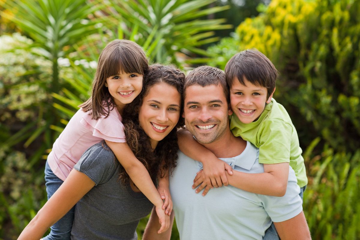 Outdoor family portrait in park.