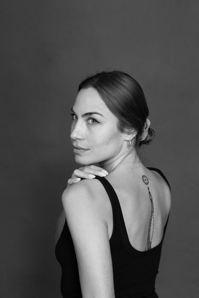 Individual posing for model headshot in studio.