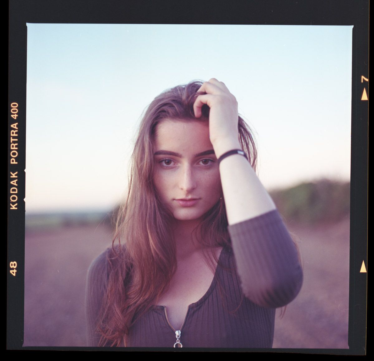 Outdoor portrait  of beautiful woman with warm sunlight.