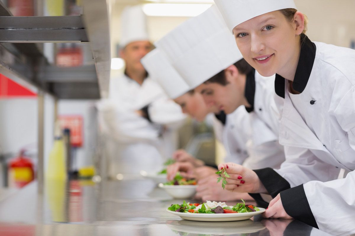 Professional chef smiling in Cork commercial kitchen.