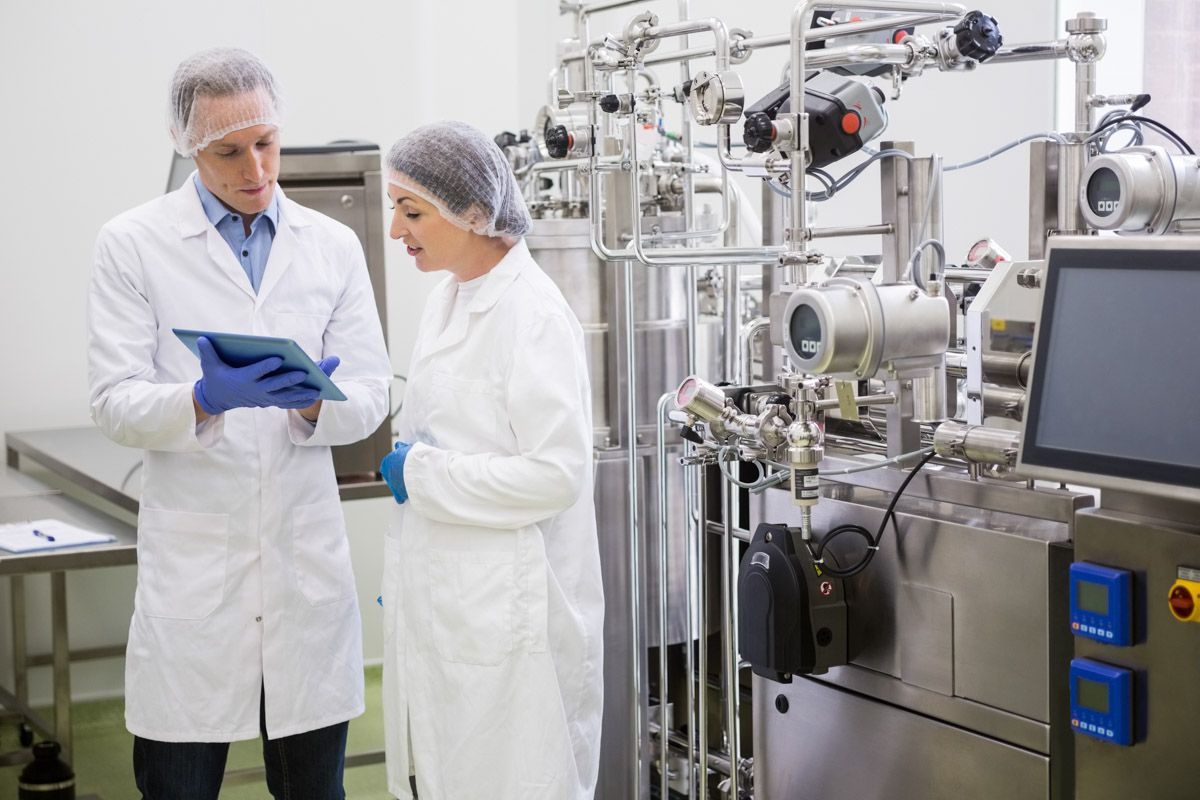 Two pharmaceutical technicians collaborating in Cork facility.