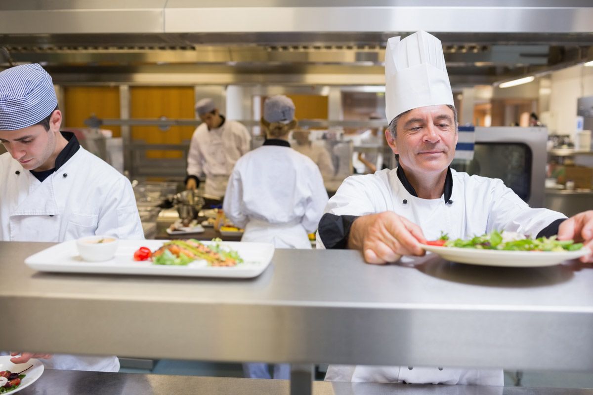 Professional restaurant kitchen with chefs at work.