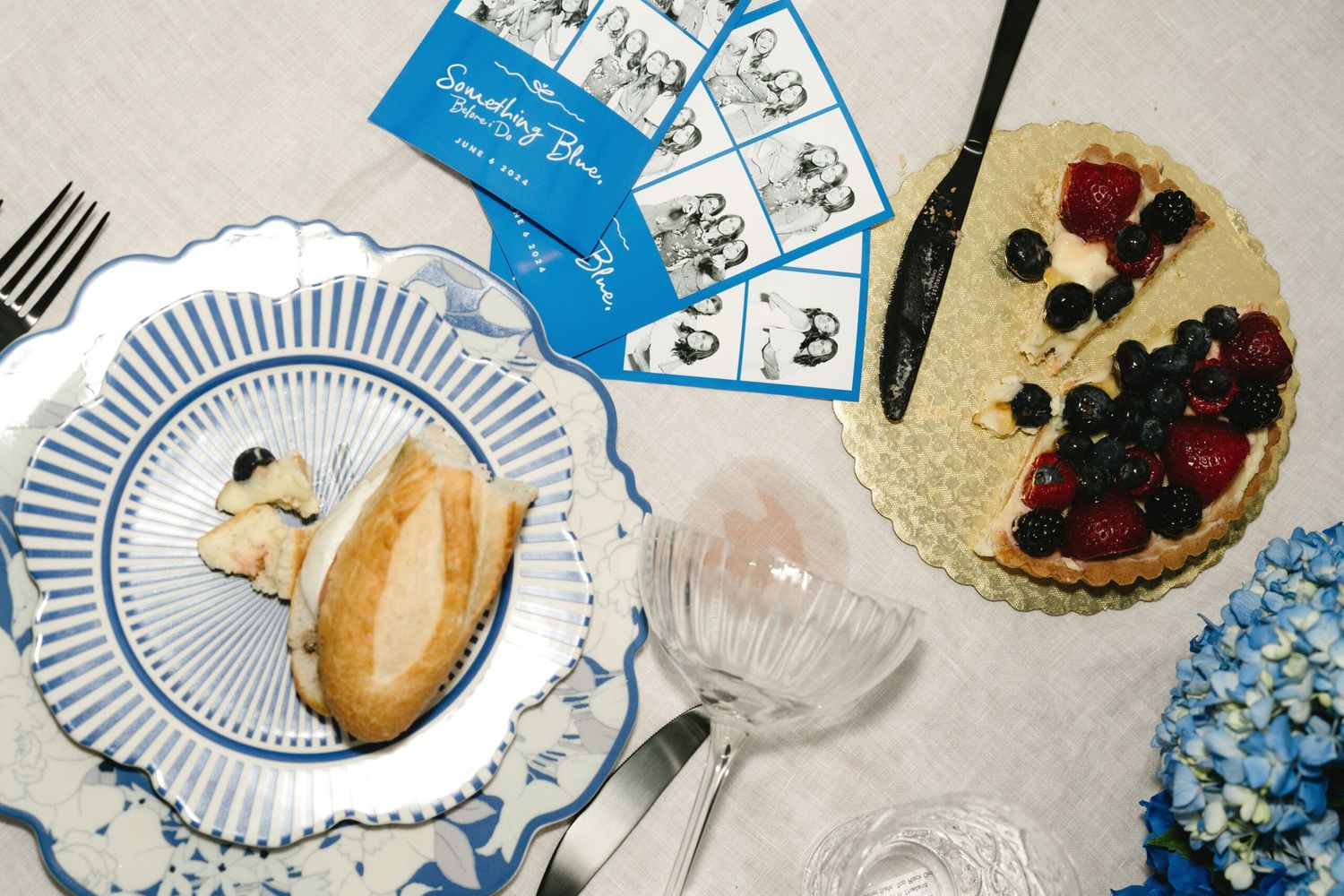Closeup of striped plates with berries and bread on an elegant table setting.