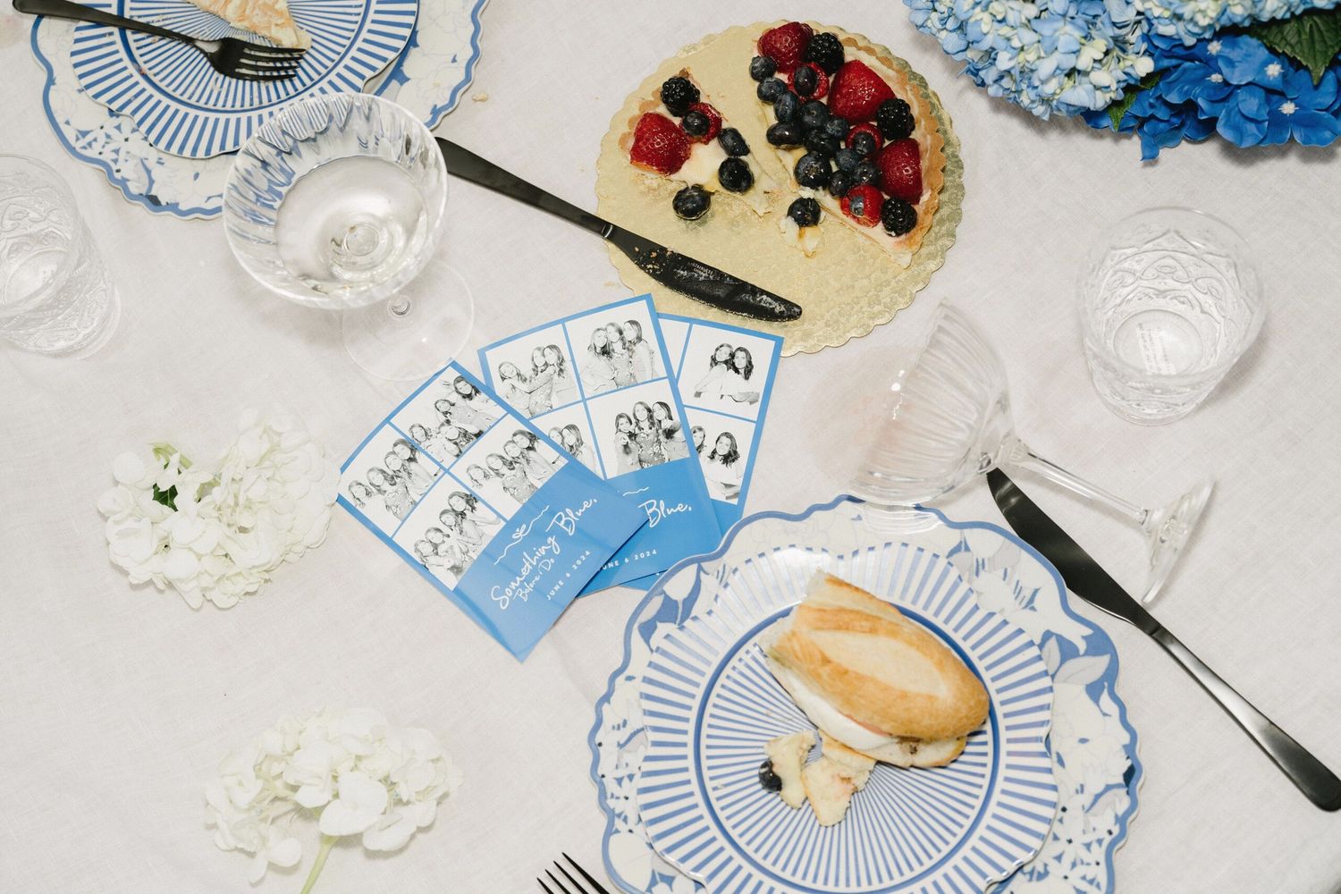 Table setting with decorative plates, berries and floral arrangements.