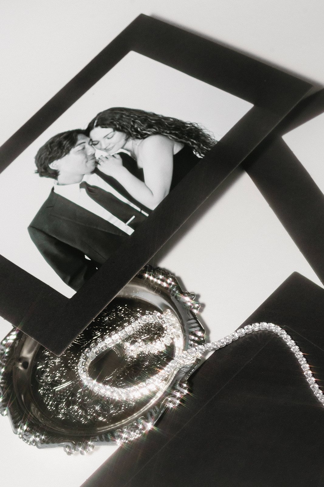 Black and white photographs displayed with shimmering disco ball and silver decor.