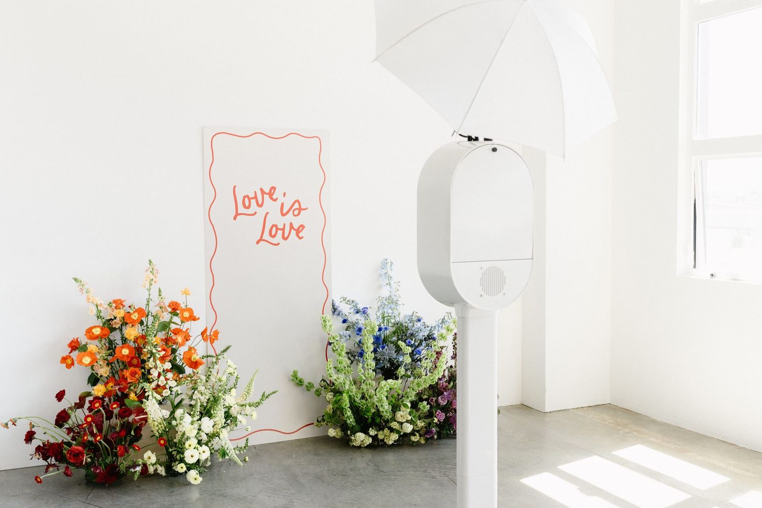 Light and airy studio setup with love text and floral decorations.