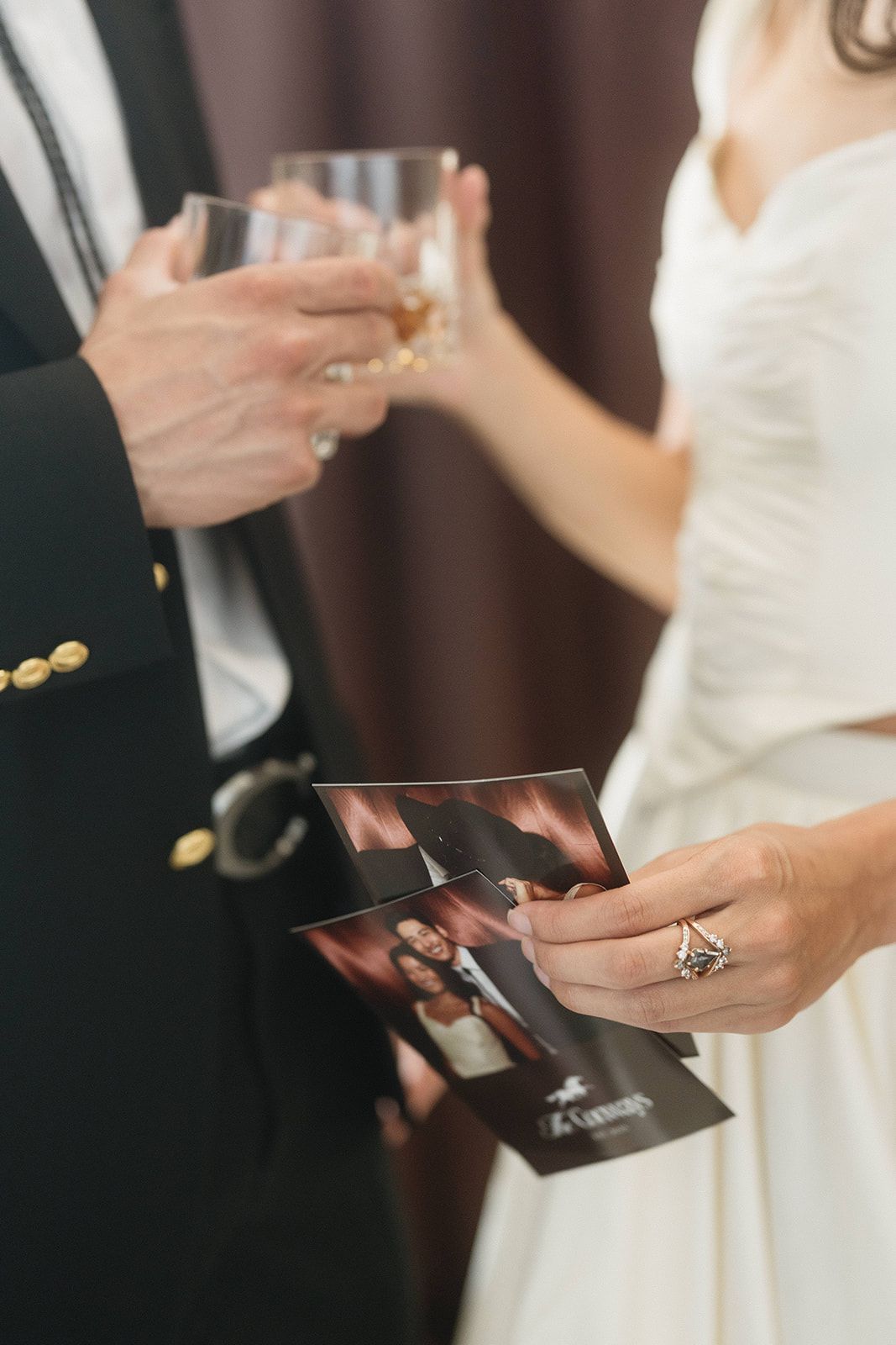 Hands exchanging small gift boxes during formal event.