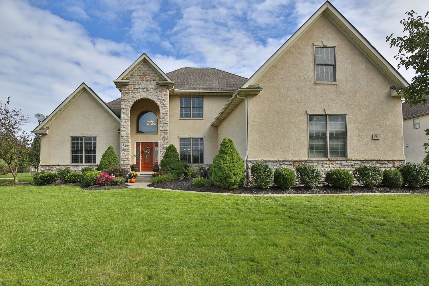 Front view of residential house with landscaped yard