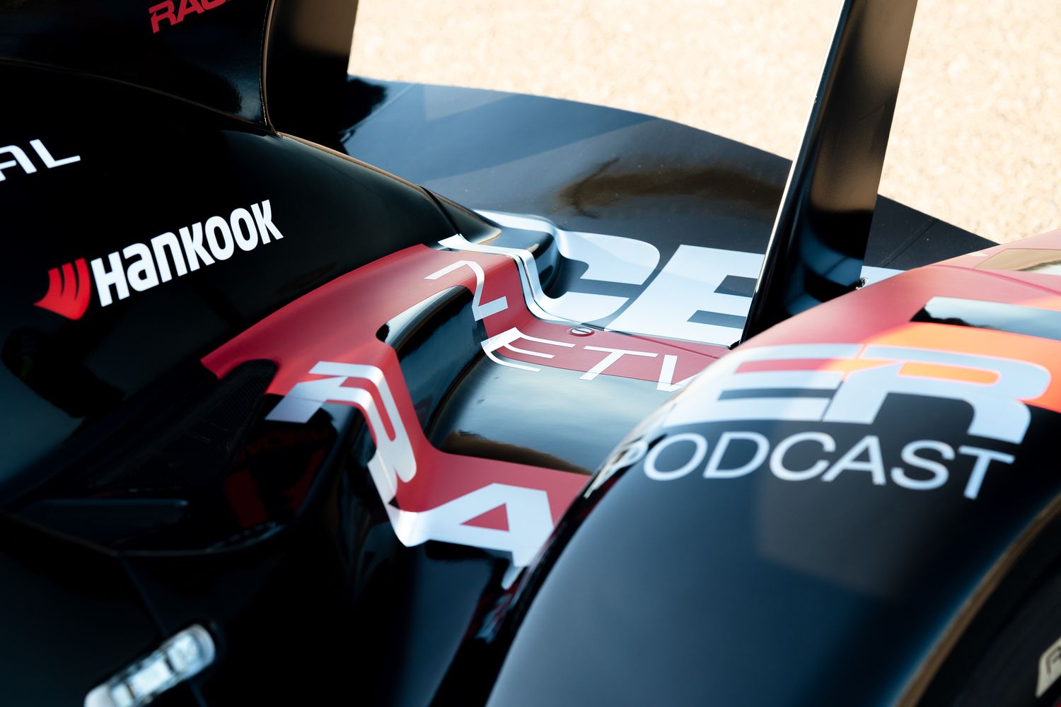 Close-up shots of Formula 1 race cars showing sleek aerodynamic details and sponsor logos on their bodywork.