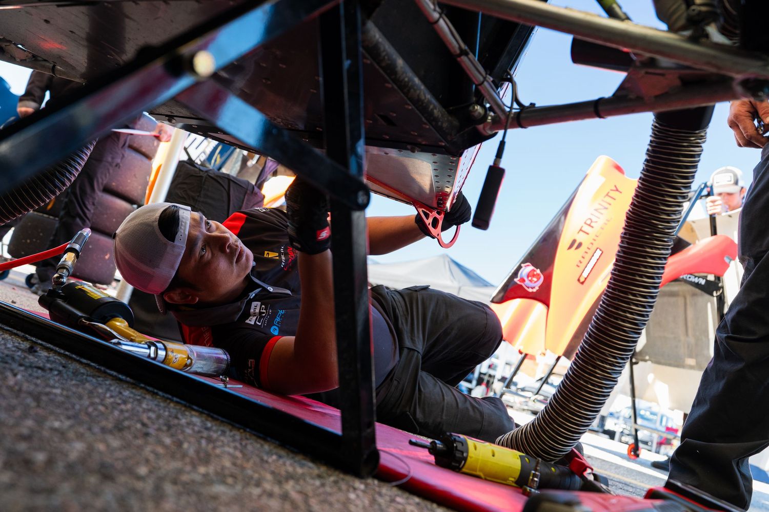 Close-up view of racing equipment and tools being prepared in a pit area.