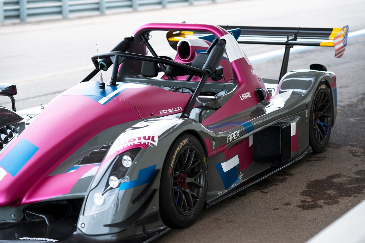 Multiple angles of a pink and blue Formula-style race car showcasing its sleek aerodynamic design.
