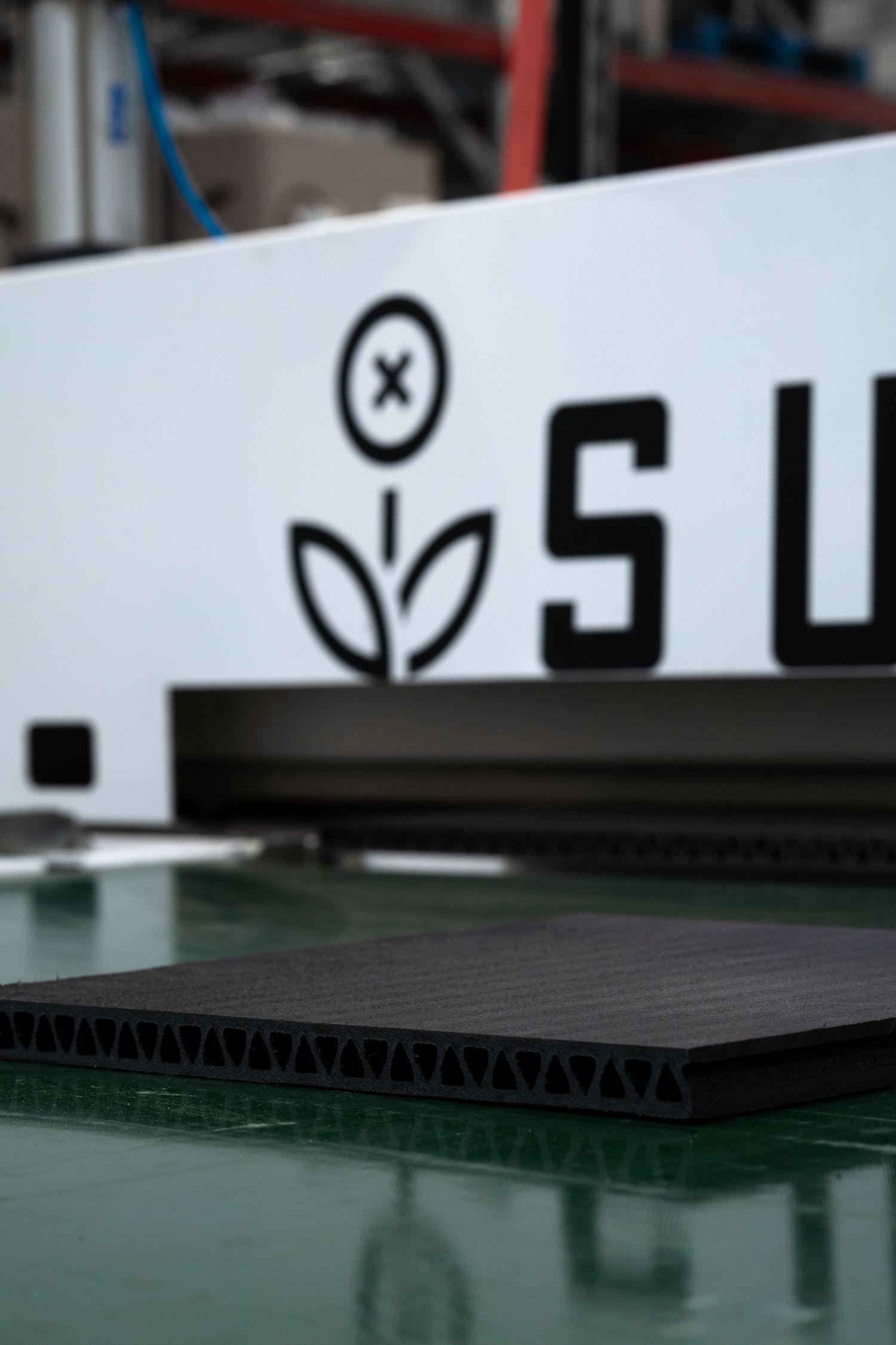 Close-up of Supersede logo and machinery parts with minimalist floral design.
