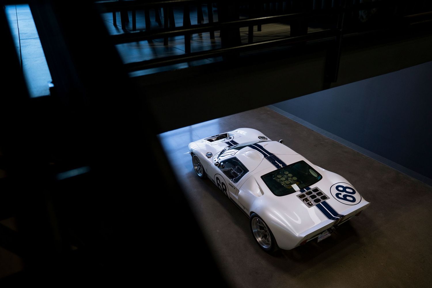 A series of dark and moody automotive photographs showing various car details and angles in low light conditions.