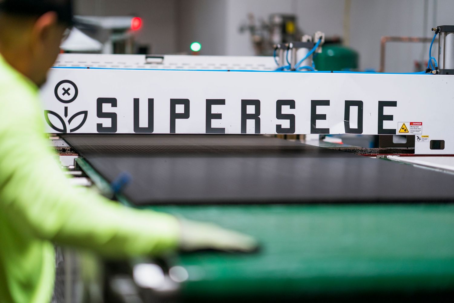 Close up of a supersede logo on modern industrial manufacturing equipment.