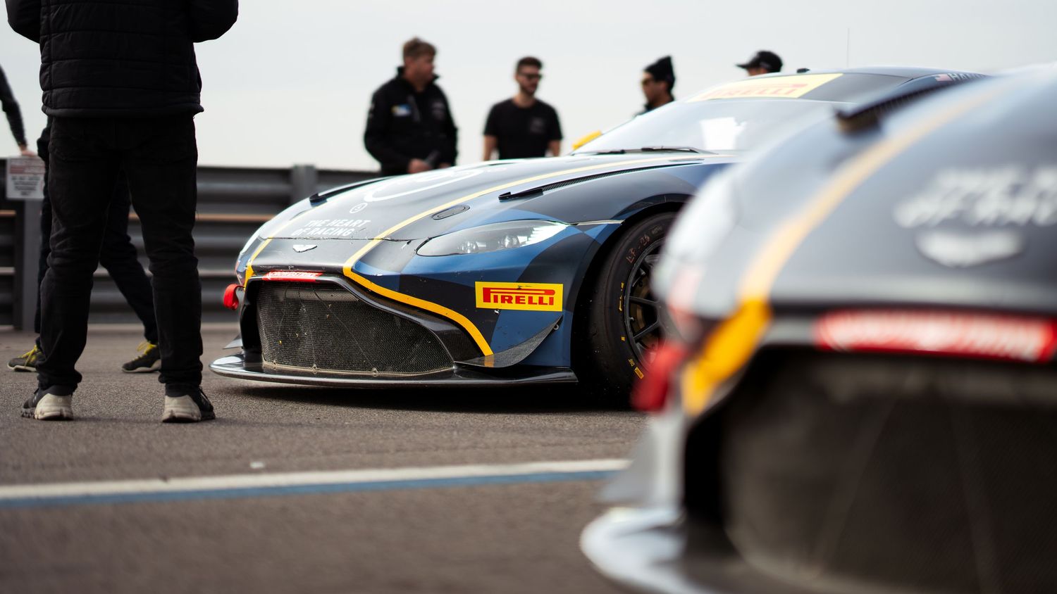 Performance cars lined up on pit lane during a race day event.