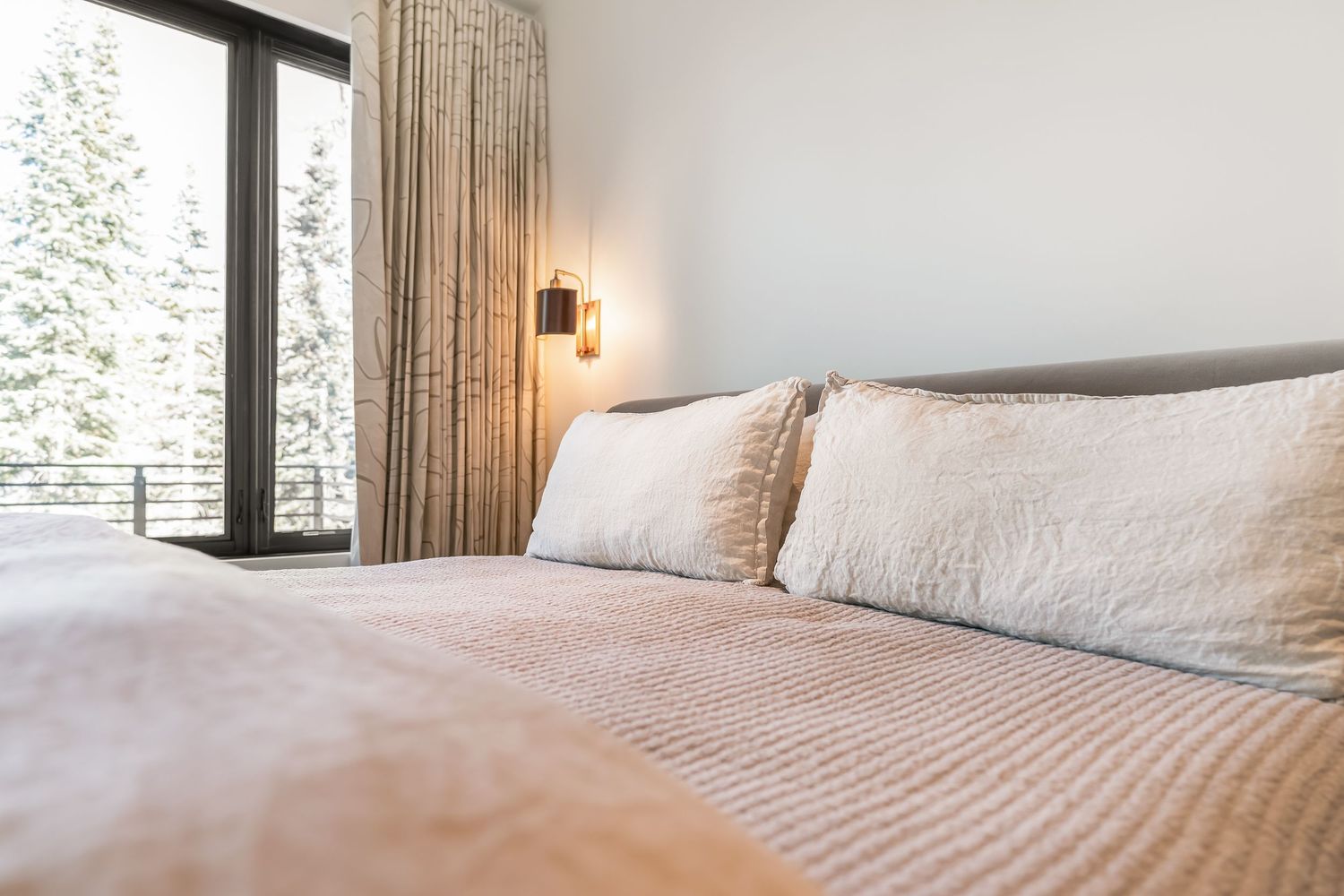 Serene bedroom interior with white bedding, natural light, and minimalist design elements.