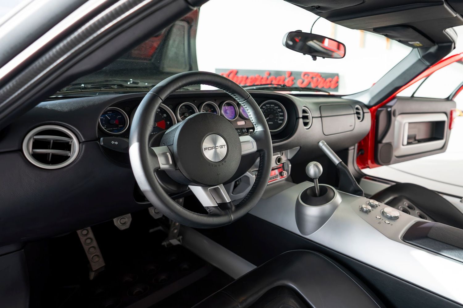 Modern sports car interior showing dashboard, steering wheel and instrument cluster.