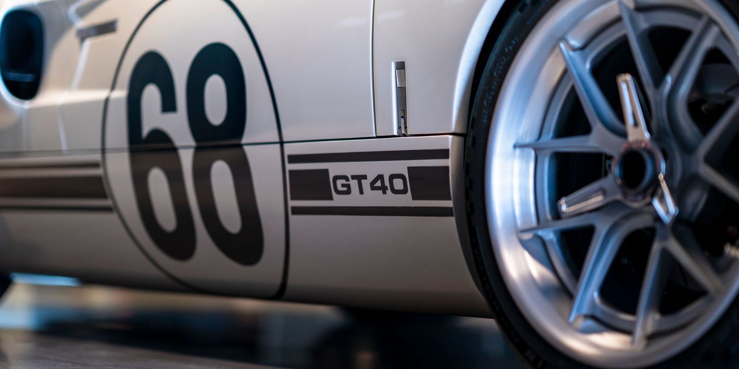 Close-up detail of a silver sports car with number 68 and GT40 badging showing a blue-tinted alloy wheel.