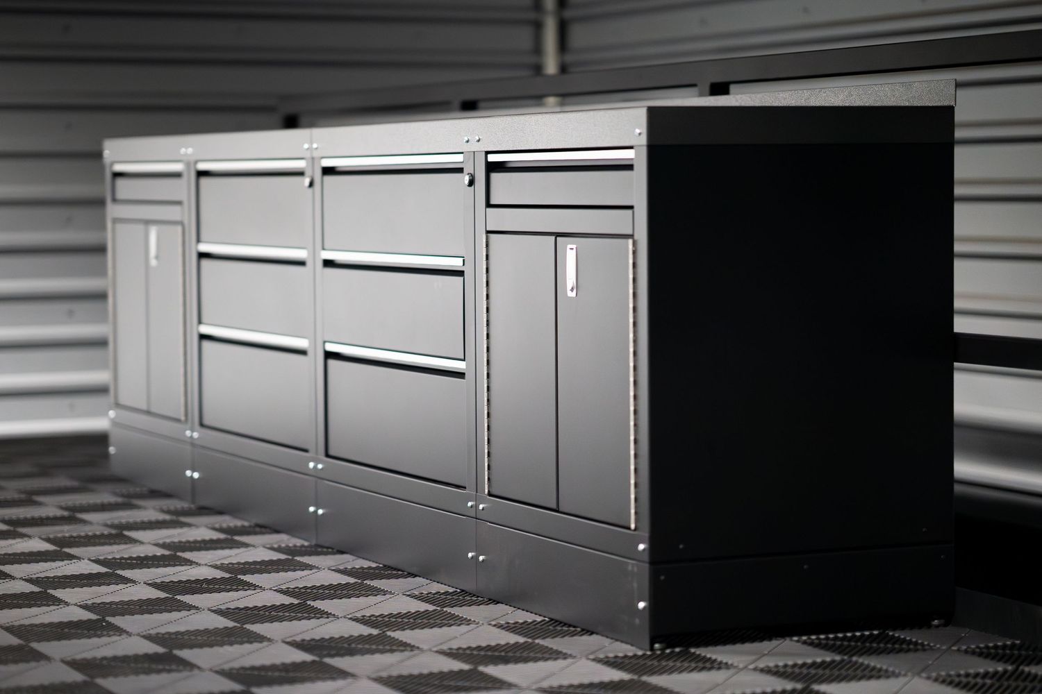 Black and white storage cabinet with multiple drawers on checkered floor.