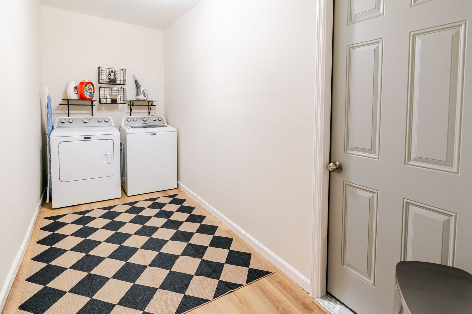 Hallway with black and white checkered floor pattern and white doors.