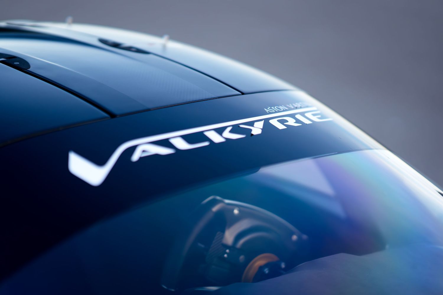 Sleek blue bodywork of a high-performance racing car under studio lighting.