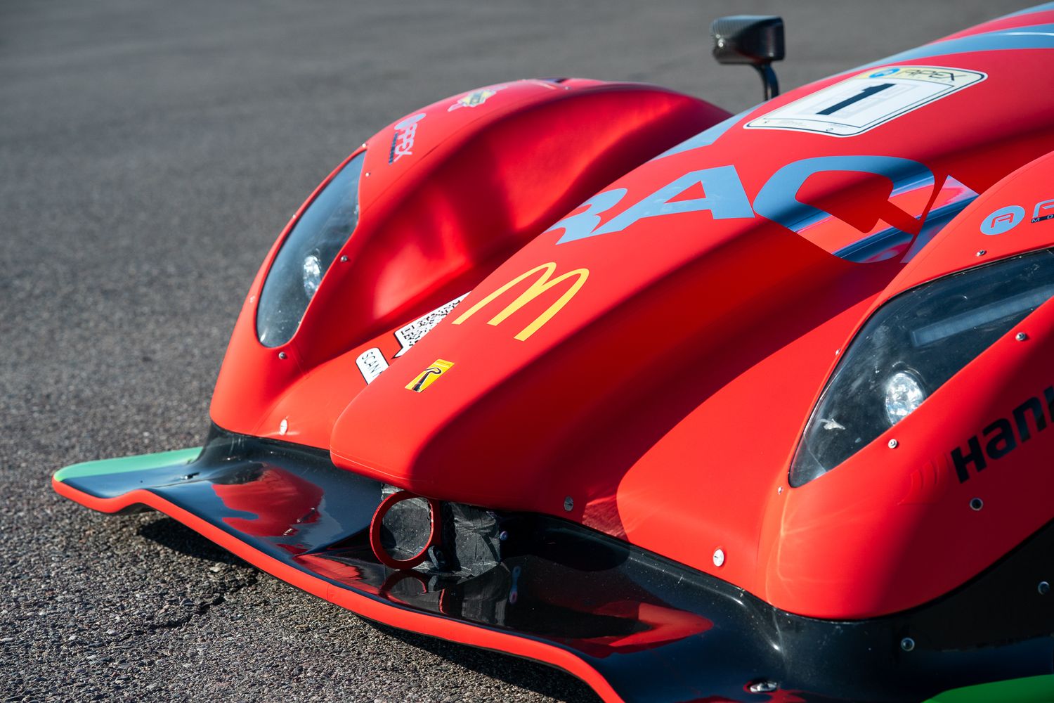 Red Radical race car front end showing aerodynamic nose cone and bodywork details.