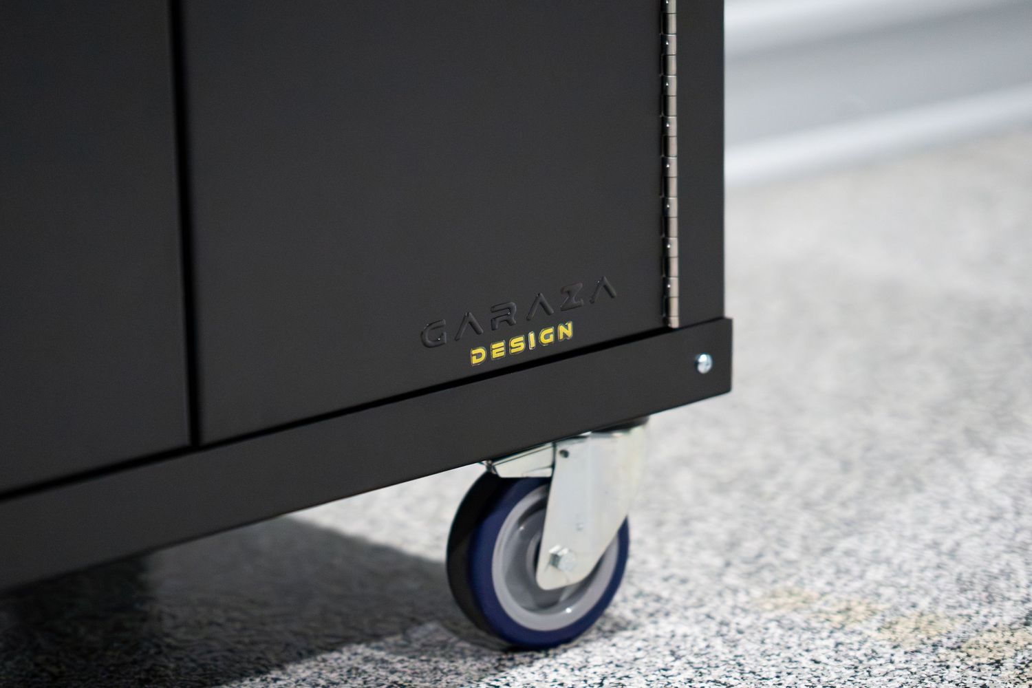 Close-up of a black cabinet wheel showing industrial-grade caster detail.