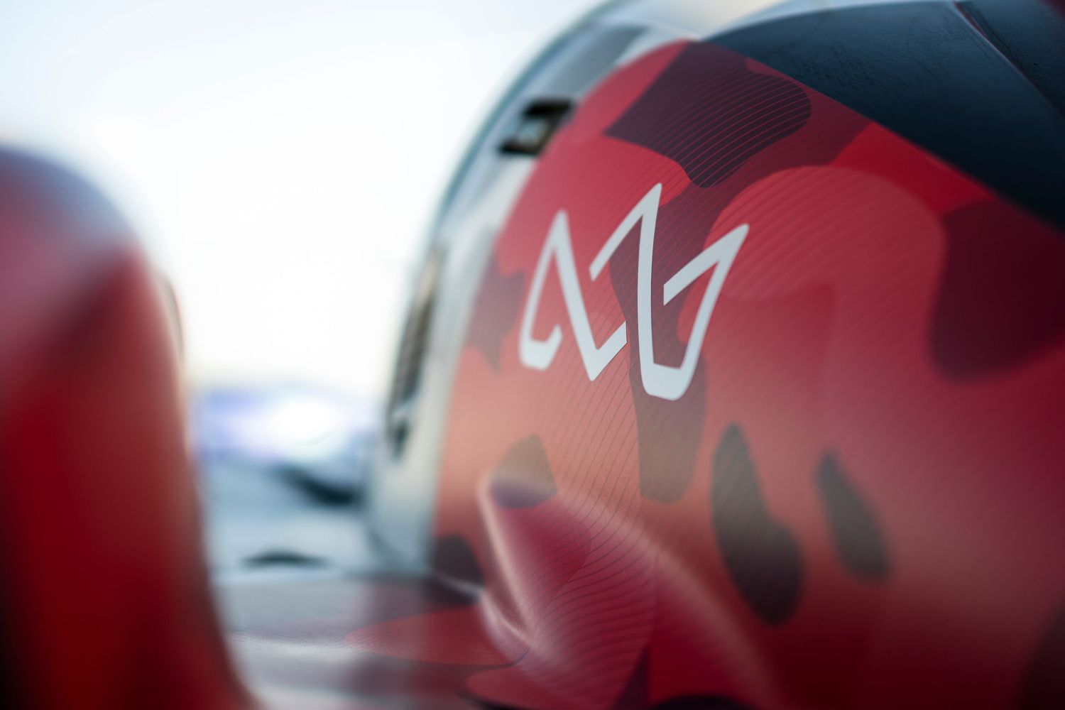 Macro shot of Crown racing team logo and branding on vehicle surface.