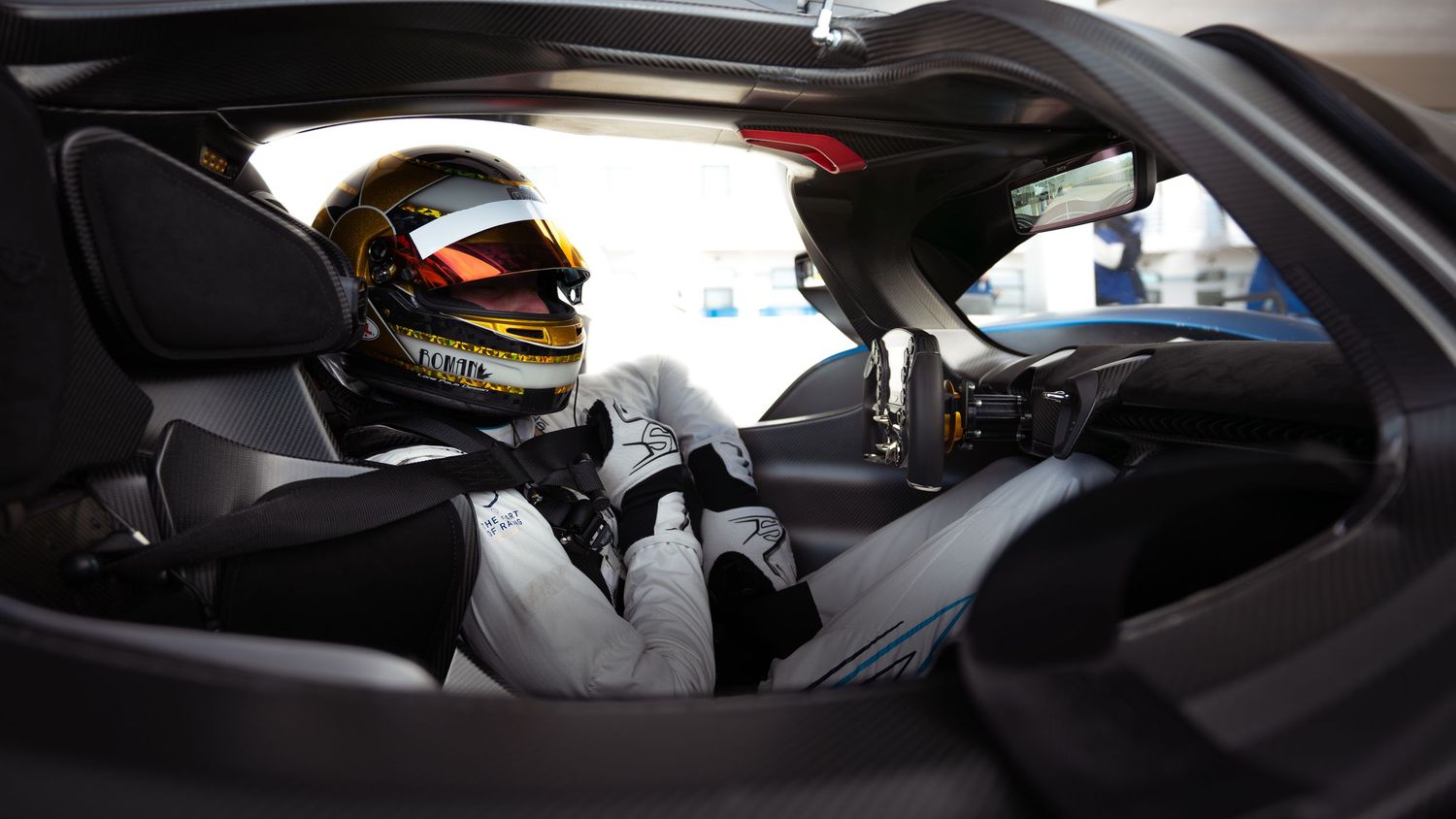 Interior cockpit view of a modern racing car showing racing equipment and controls.