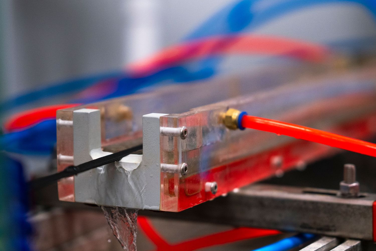 Close-up of industrial machine components with red and blue wiring connections.