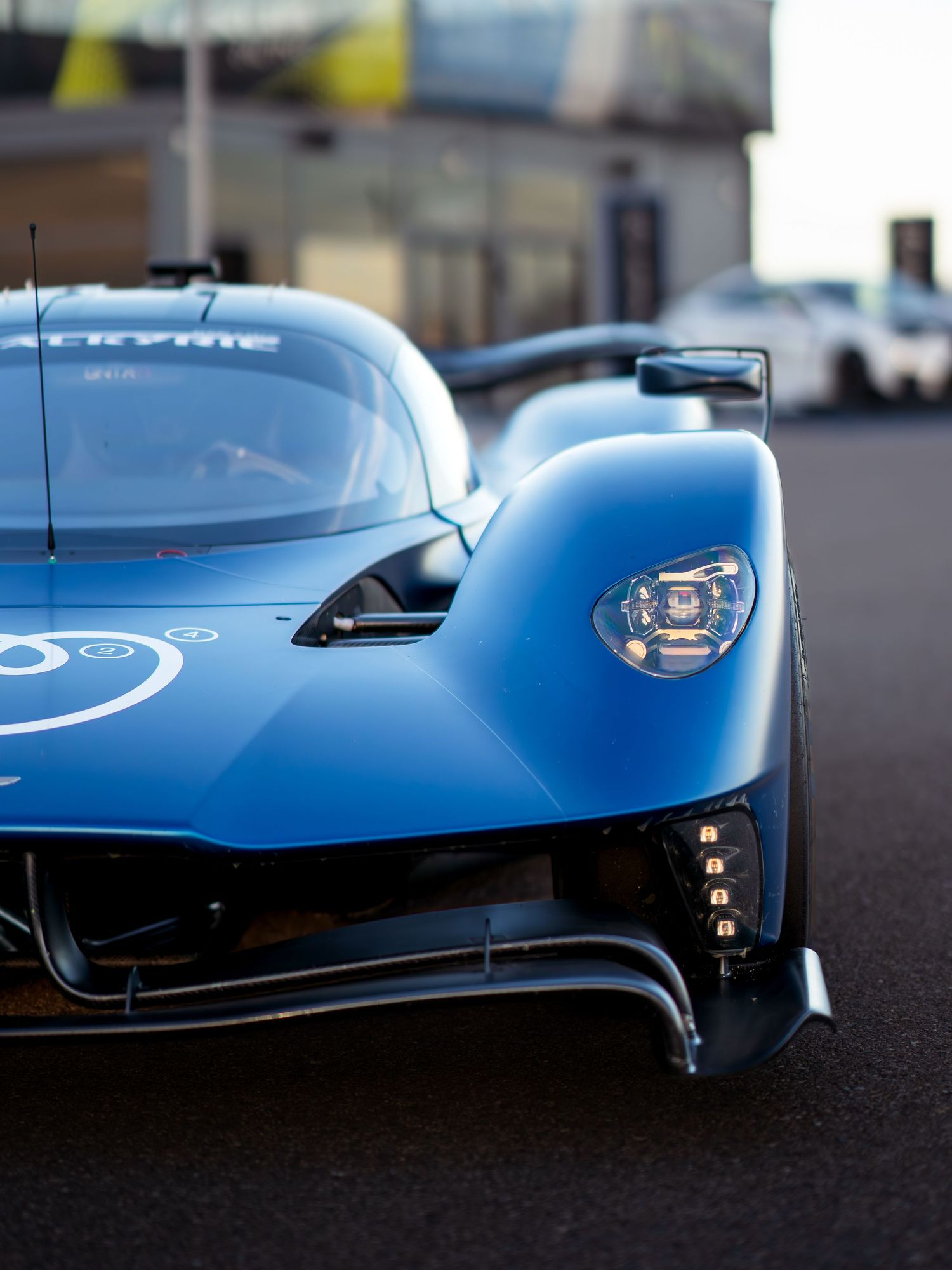Close-up front view of blue Aston Martin Valkyrie showing aerodynamic details.