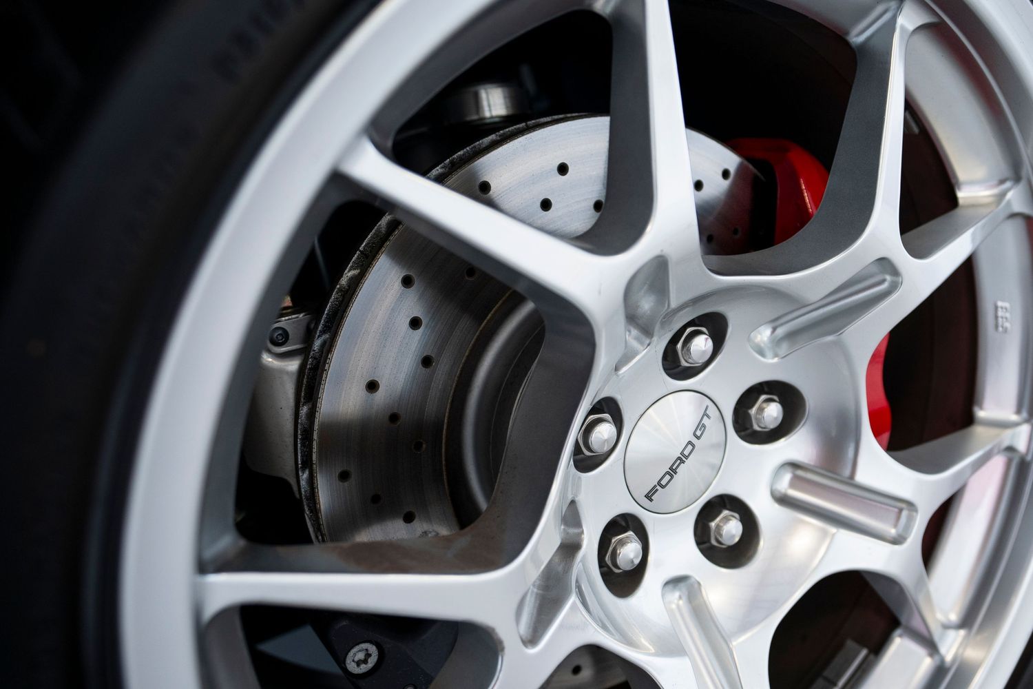 Close-up macro shots of silver alloy car wheels with red brake calipers visible through the spokes.