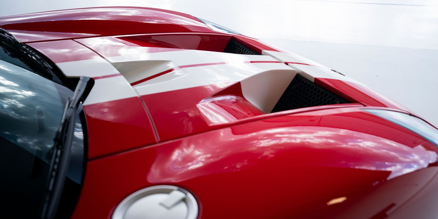 Series of angles showcasing a red supercar's aerodynamic body lines.