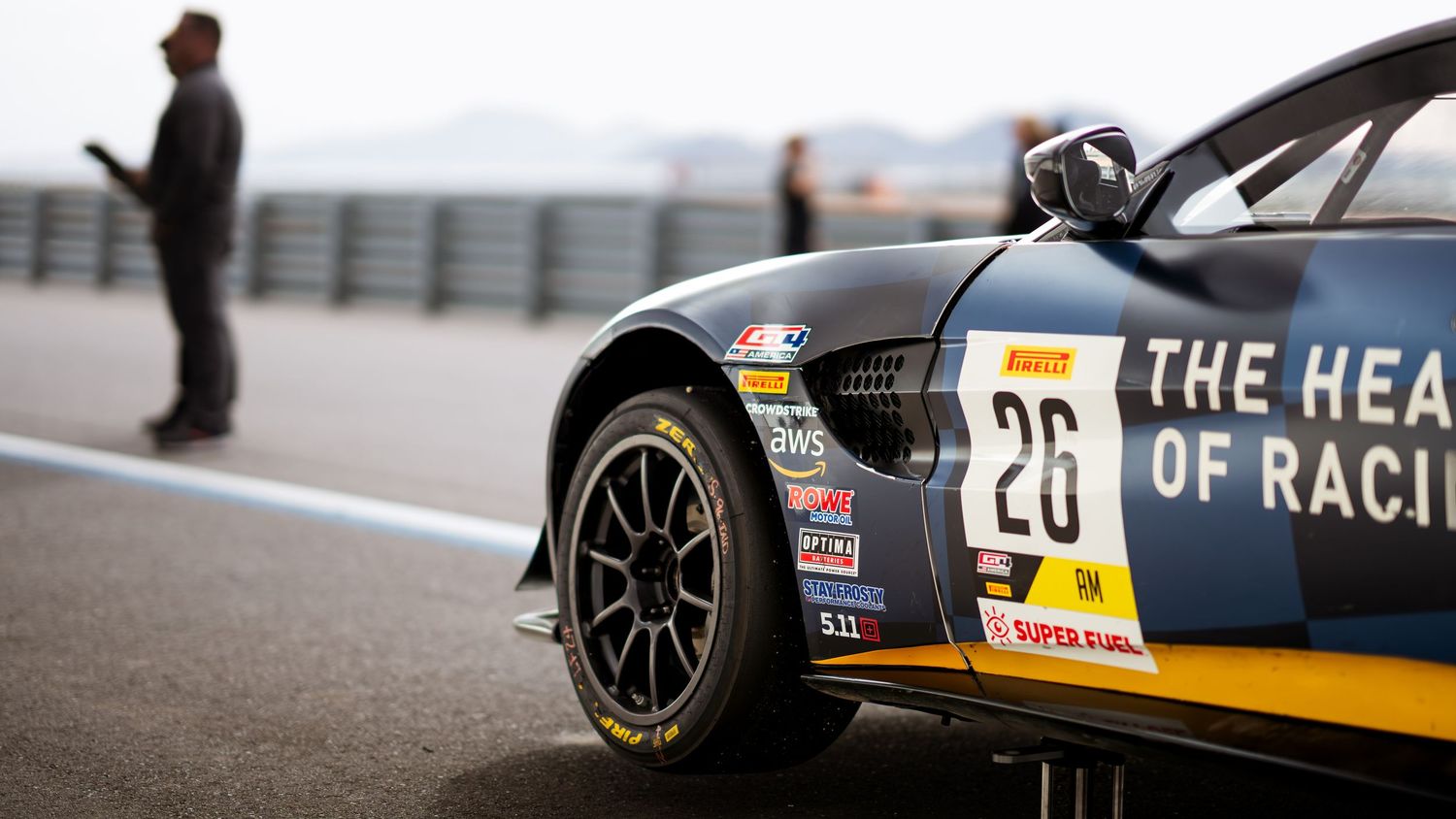 Close up of a black race car with number 26 and racing decals on track.