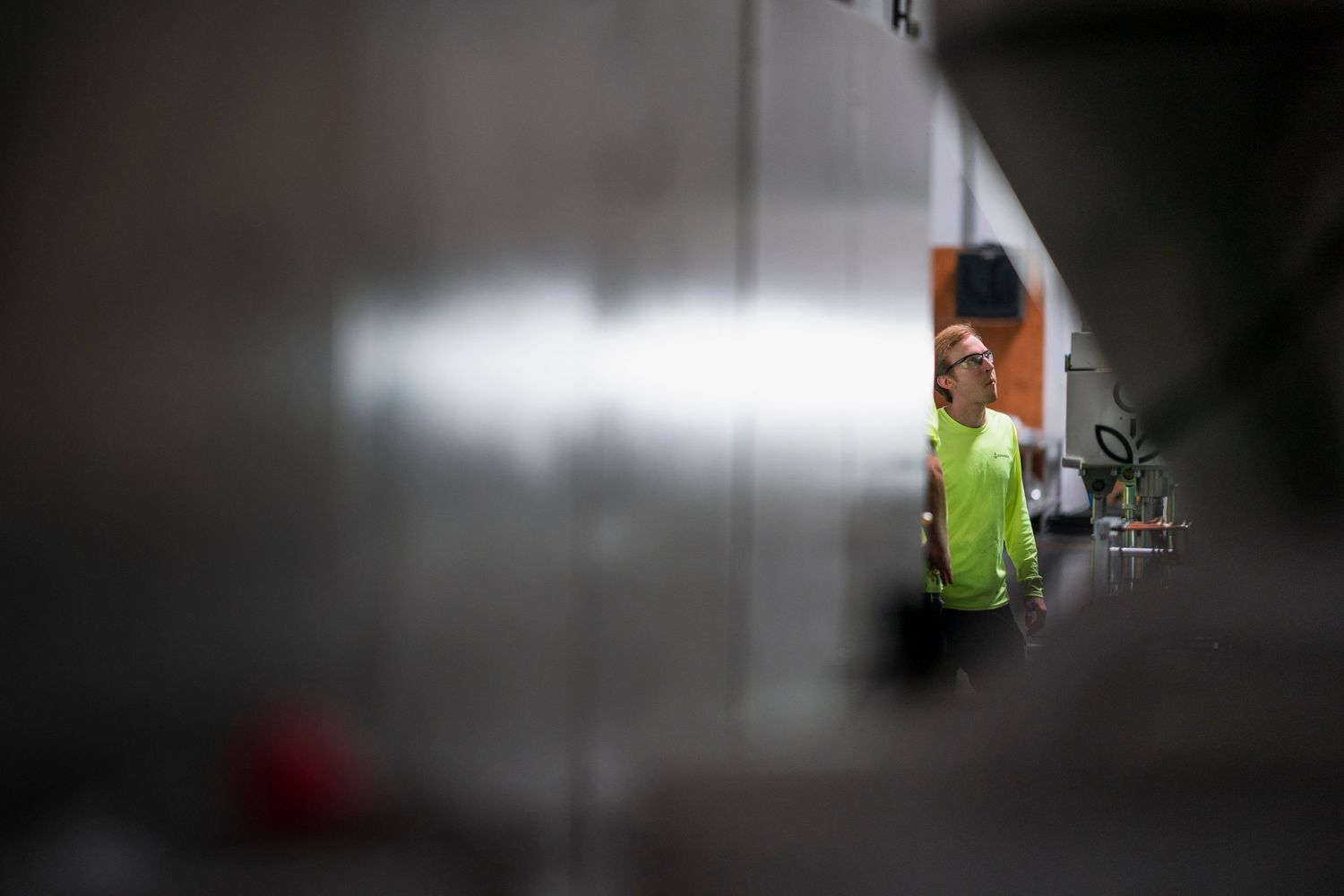 View through industrial machinery showing workspace with equipment in soft focus.