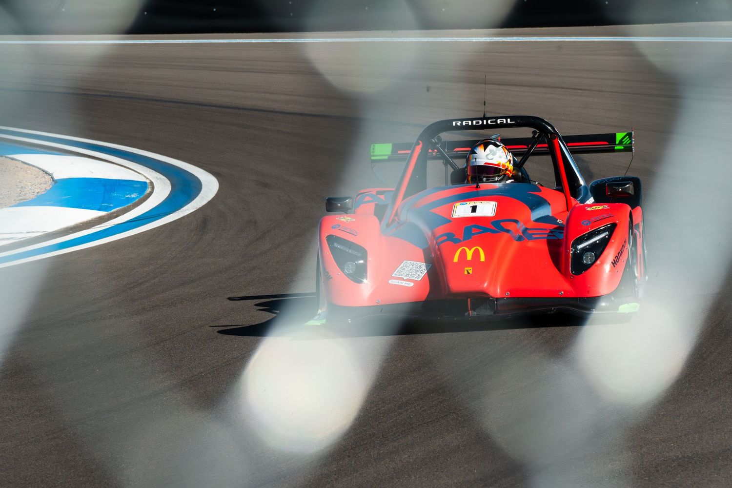 Multiple Formula 1 race cars competing on a curved track with dramatic motion blur.