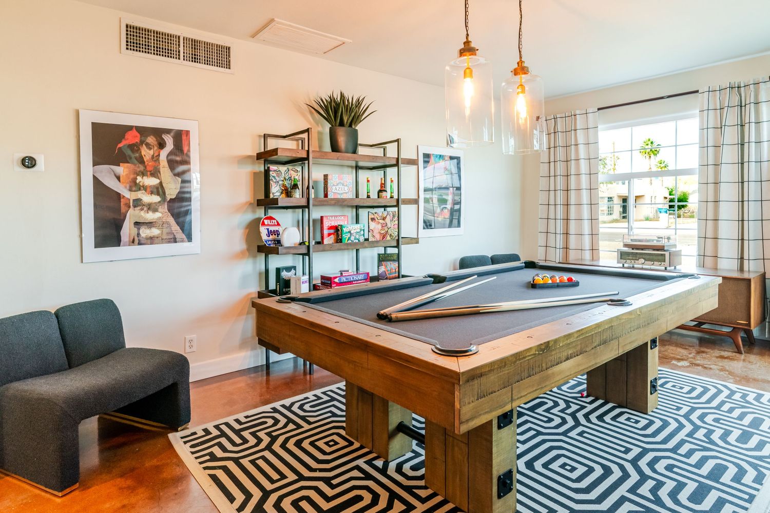 Contemporary living room featuring geometric rug and wooden coffee table with natural lighting.