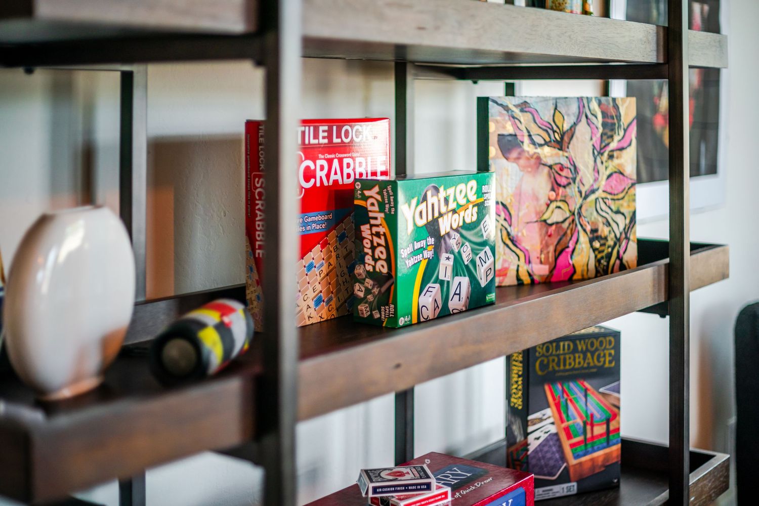 A collection of colorful books and magazines arranged on wooden shelves in a retail store display.