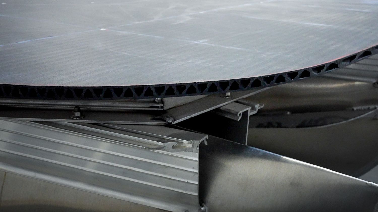 Industrial machinery detail showing corrugated metal panels and structural components.