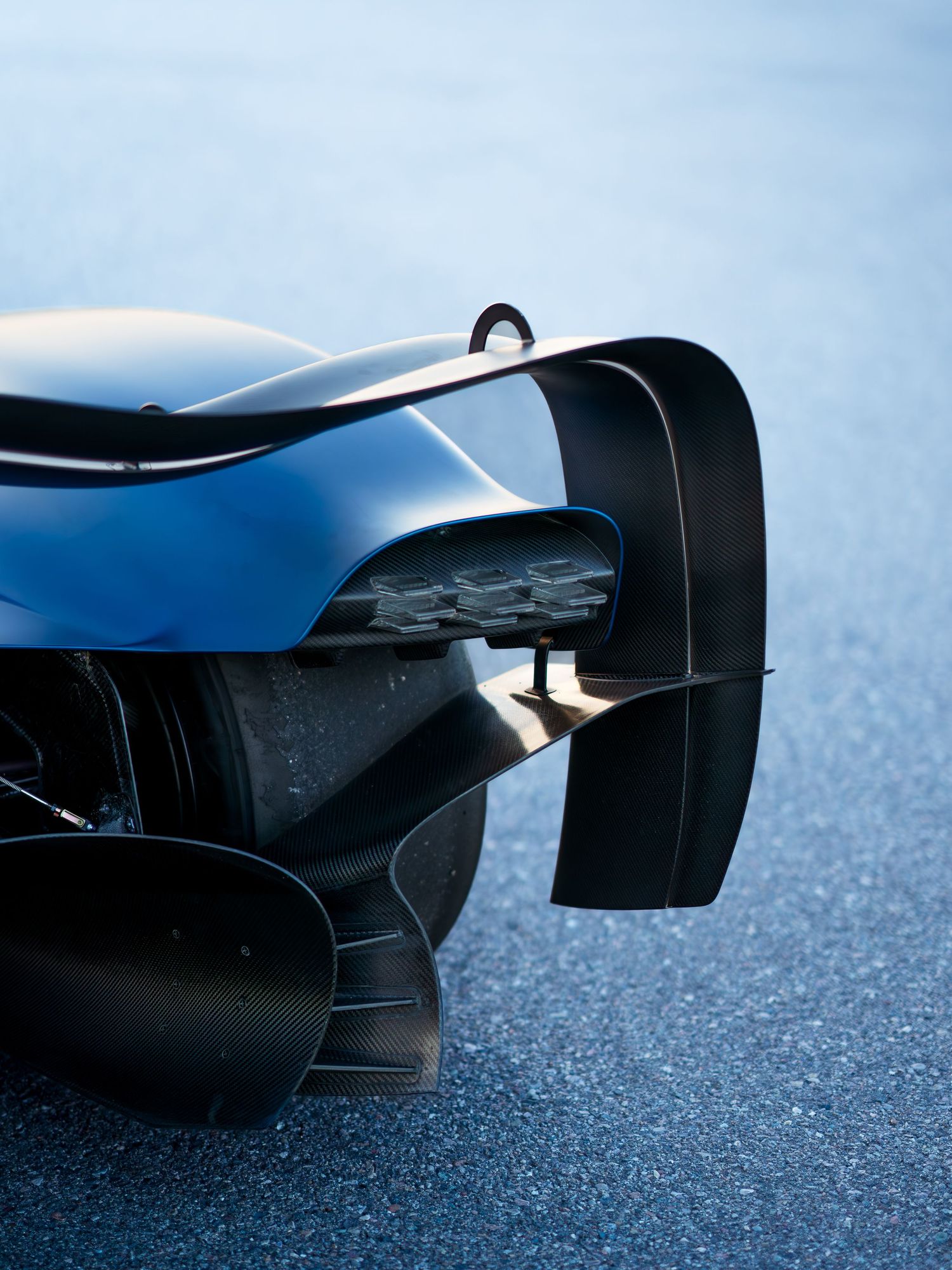 Close-up detail of rear diffuser and aerodynamic elements on modern race car.