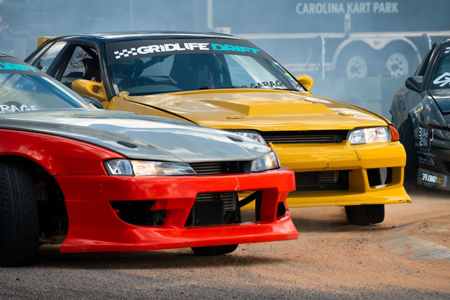 Red and yellow modified drift cars lined up at Carolina Kart Park during a Gridlife motorsport event.