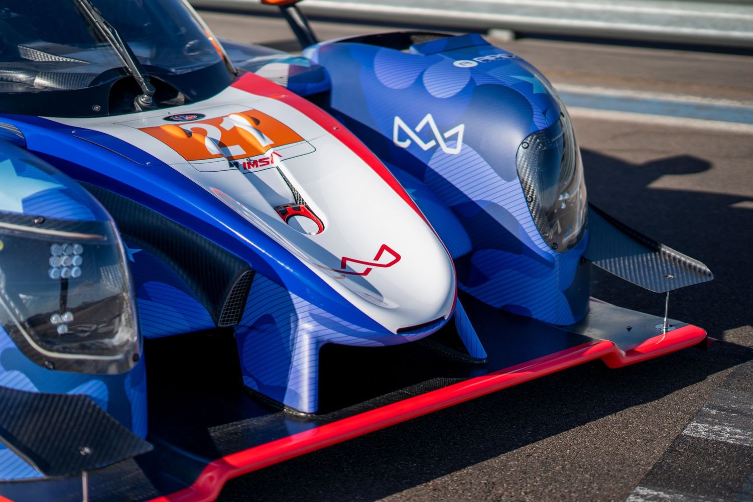 Blue and red racing car aerodynamic elements photographed from side angle.