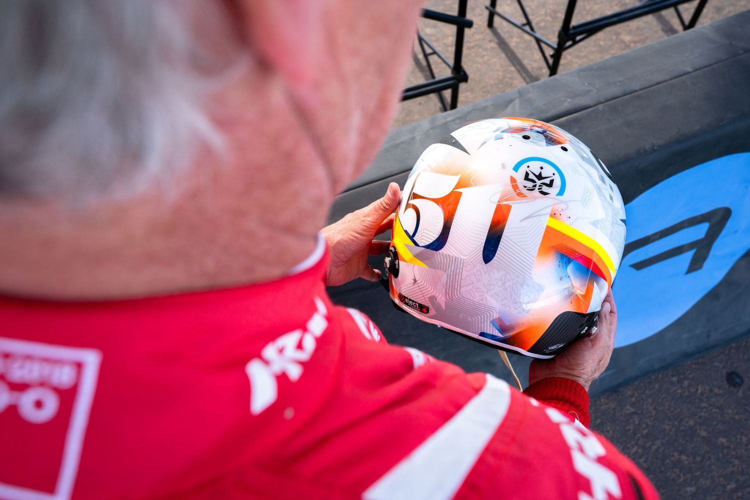 Close-up view of a Formula 1 racing car's front wing and nose cone during a pit stop.