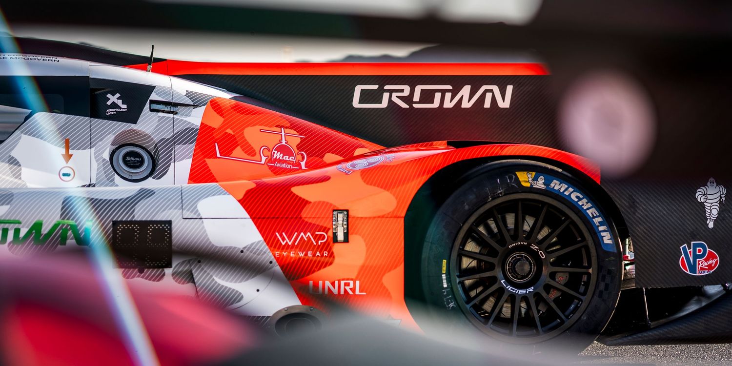 Close-up detail shot of sportscars showing sponsor logos and aerodynamic elements.
