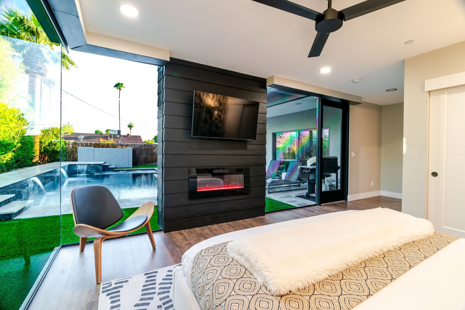 Spacious living room with floor-to-ceiling windows, modern furniture, and natural light flooding the space.