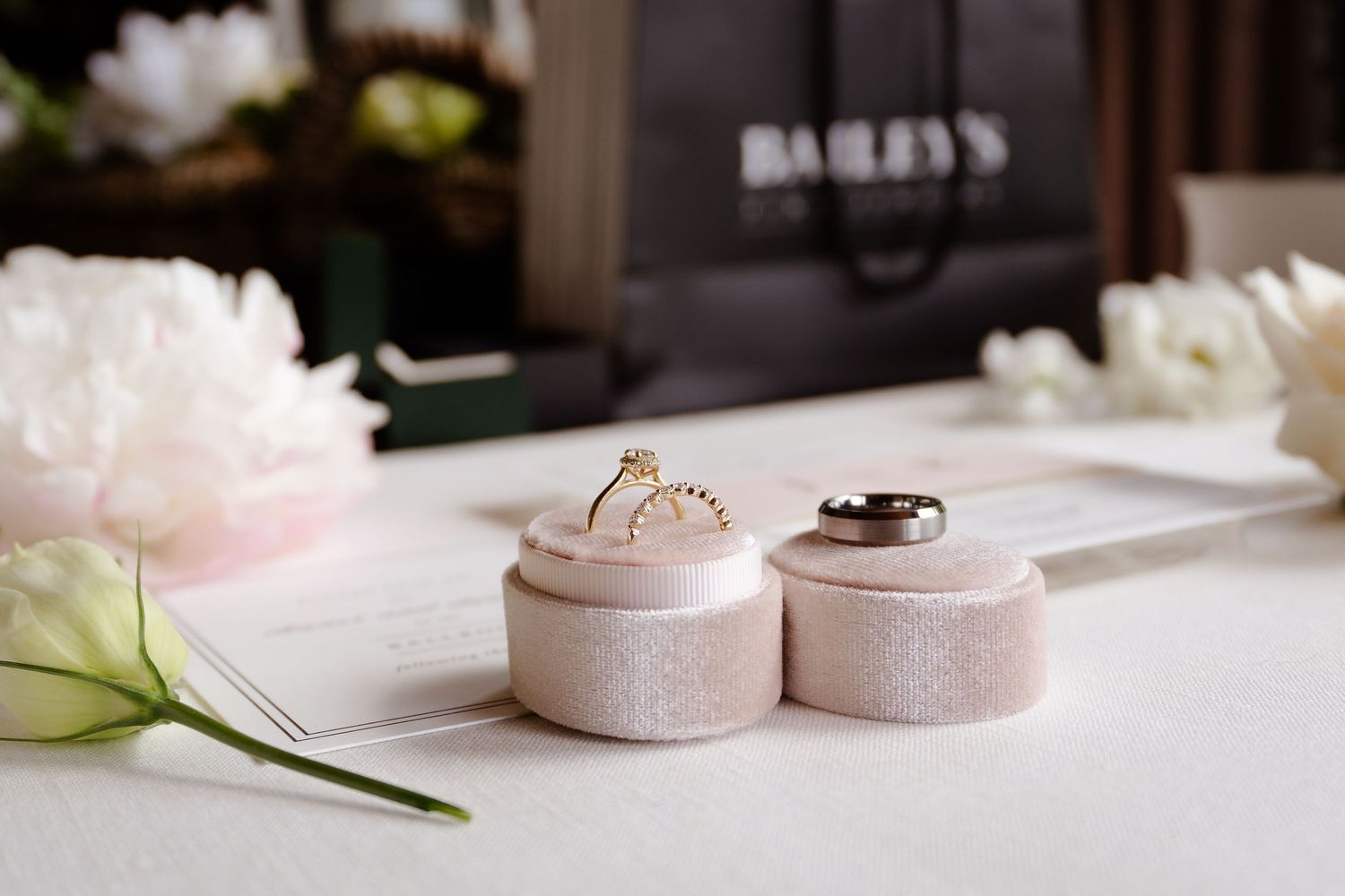 Wedding detail shot of delicate pink and white decor items on table.