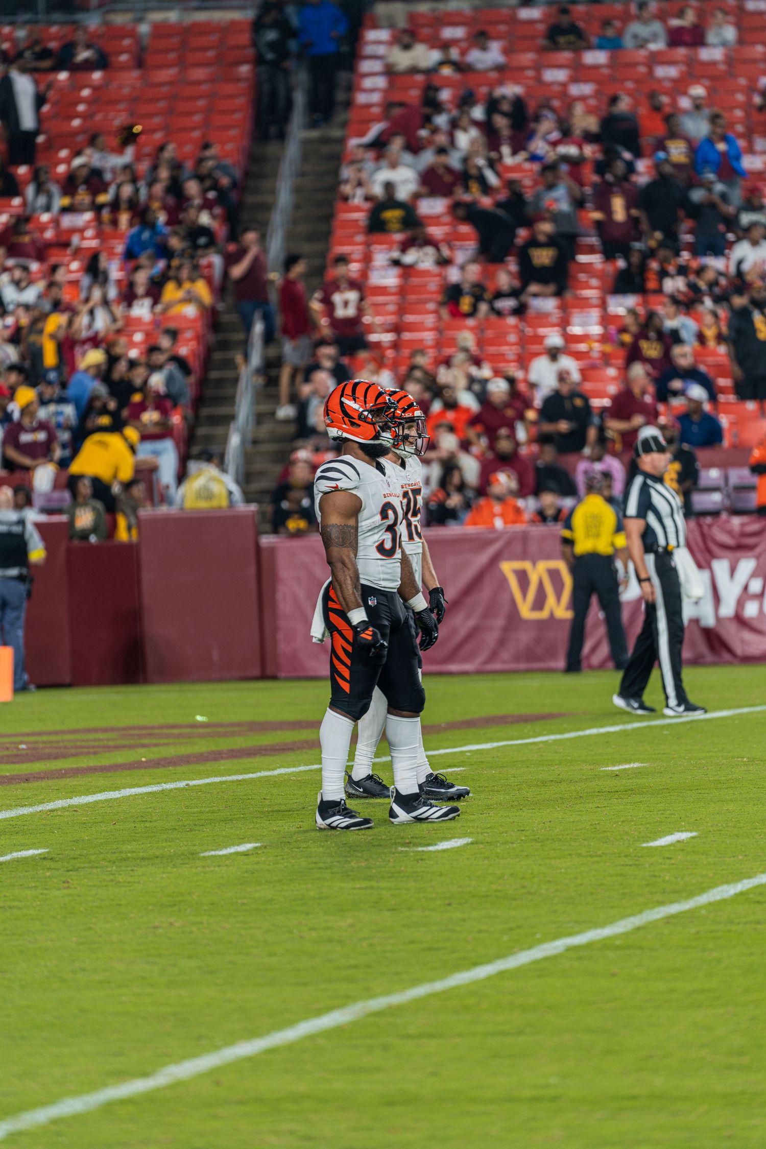 Players line up on the field during a professional football game.